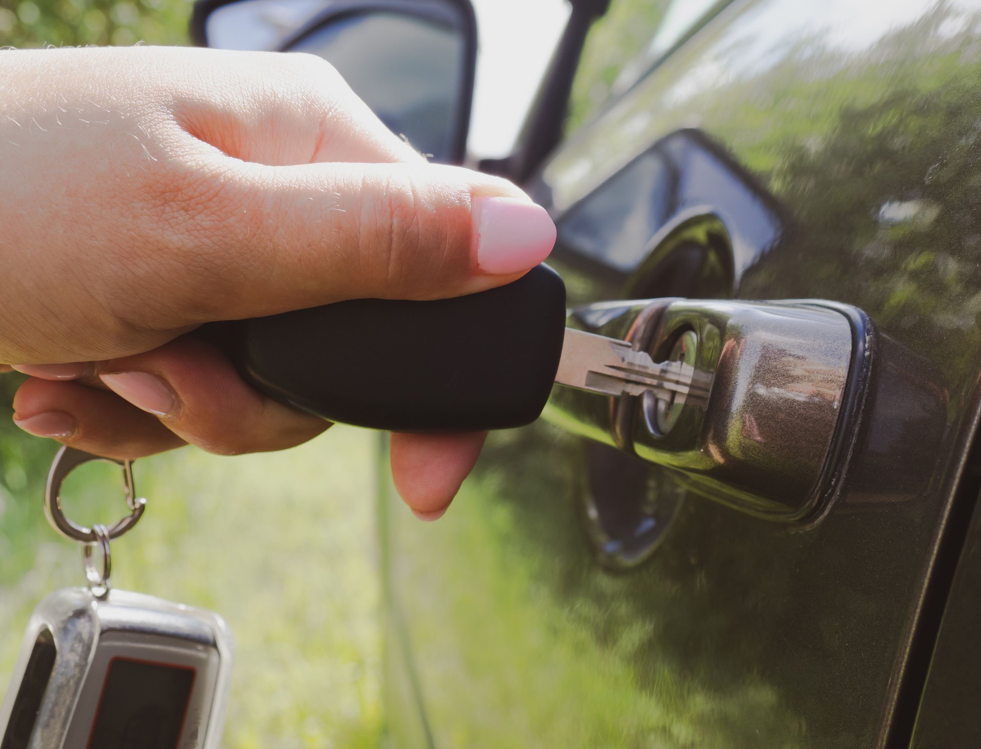girl opens the car with a key close-up